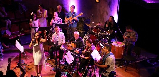 pessoas tocando instrumentos no palco