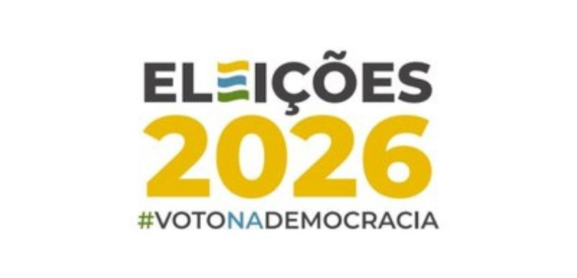 banner com fundo branco sobre o qual se observa a logomarca das Eleições 2026. São três linhas. ...