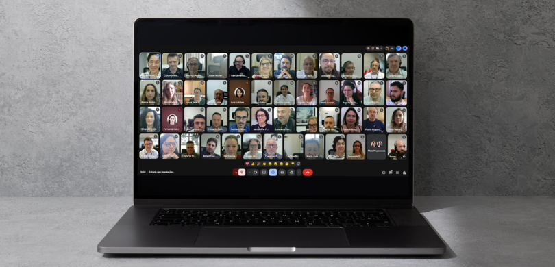 Fotografia de um notebook de cor cinza escura aberto sobre uma superfície plana e clara, posicio...