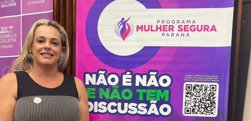 TRE-PR participa de Encontro Estadual das Procuradorias Especiais da Mulher Fotografia de uma mulher loira que usa um vestido preto, com detalhes em prata, posando sorrindo...