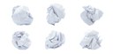 Seis bolinhas de papel amassadas sobre um fundo branco.