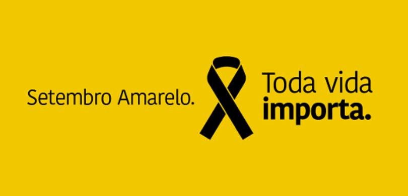 Em um banner com fundo amarelo, observa-se um laço preto centralizado. Também em preto, lê-se “S...