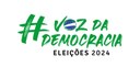 Banner em fundo branco, no qual se lê, em verde bandeira e letras estilizadas, “#Voz da Democrac...